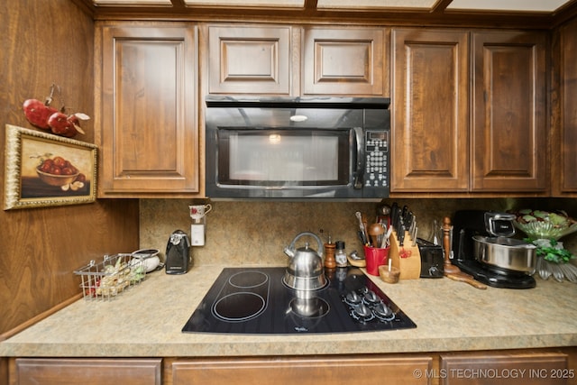 3504 S Rolling Oaks Dr, Tulsa, OK 74107 - kitchen with black appliances, decorative backsplash, and light countertops