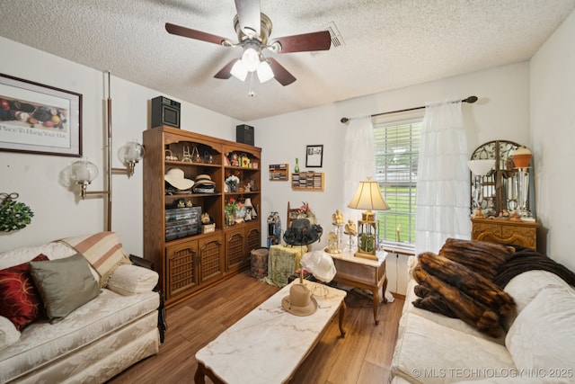 3504 S Rolling Oaks Dr, Tulsa, OK 74107 - living area with a textured ceiling, ceiling fan, and wood finished floors
