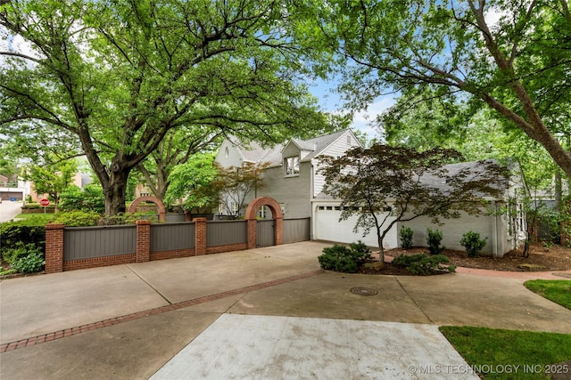 2508 Terwilleger Blvd, Tulsa, OK 74114 - view of front of house featuring concrete driveway, a fenced front yard, a gate, and an attached garage