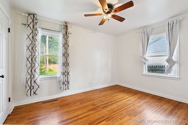 2653 S Vandalia Ave, Tulsa, OK 74114 - empty room with wood finished floors, healthy amount of natural light, ornamental molding, and ceiling fan