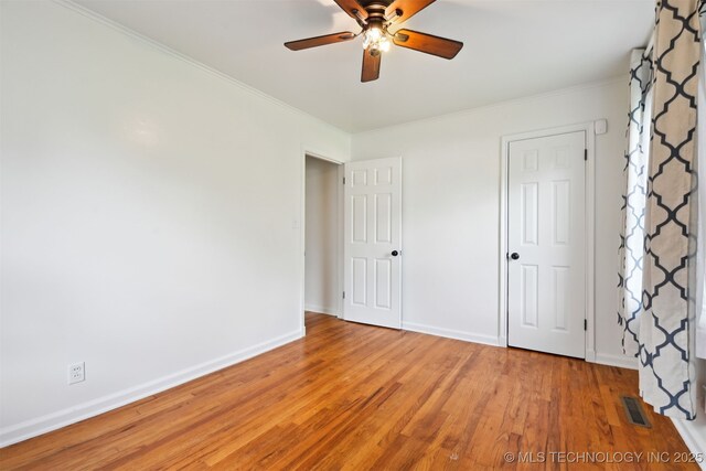 2653 S Vandalia Ave, Tulsa, OK 74114 - unfurnished bedroom featuring light wood-style floors, ornamental molding, and ceiling fan