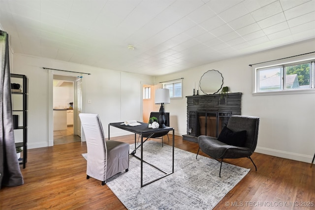 2653 S Vandalia Ave, Tulsa, OK 74114 - dining space with healthy amount of natural light, a fireplace, and wood finished floors