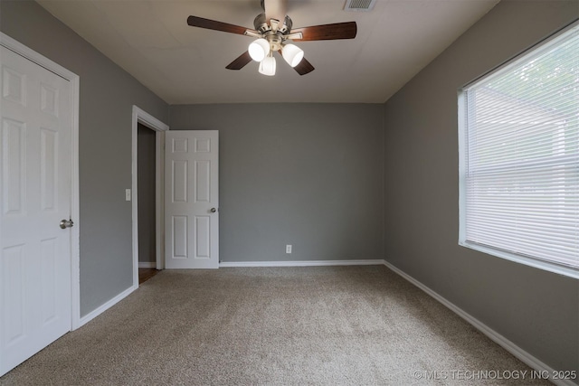708 S Toledo Ave, Tulsa, OK 74112 - unfurnished bedroom featuring carpet, baseboards, and ceiling fan