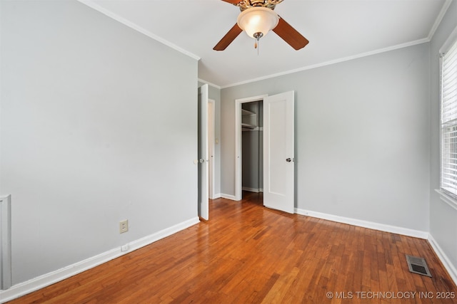 6315 E 5th Pl, Tulsa, OK 74112 - unfurnished bedroom featuring crown molding, wood finished floors, baseboards, ceiling fan, and a closet