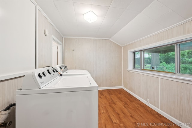 6315 E 5th Pl, Tulsa, OK 74112 - laundry room featuring washing machine and dryer, ornamental molding, light wood-style floors, baseboards, and wood walls