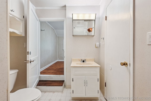 6315 E 5th Pl, Tulsa, OK 74112 - bathroom with vanity, toilet, baseboards, and ornamental molding