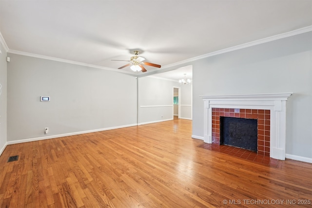 6315 E 5th Pl, Tulsa, OK 74112 - unfurnished living room with ceiling fan, light wood-type flooring, crown molding, a fireplace, and a chandelier