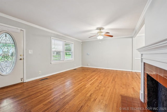 6315 E 5th Pl, Tulsa, OK 74112 - unfurnished living room with a ceiling fan, light wood-style floors, ornamental molding, a fireplace, and baseboards
