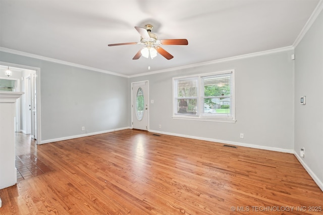 6315 E 5th Pl, Tulsa, OK 74112 - unfurnished living room featuring a ceiling fan, crown molding, wood finished floors, and baseboards