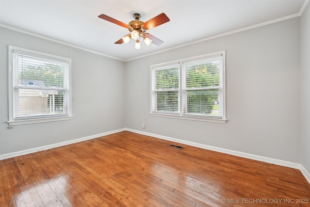 6315 E 5th Pl, Tulsa, OK 74112 - unfurnished room featuring healthy amount of natural light, crown molding, hardwood / wood-style floors, baseboards, and a ceiling fan