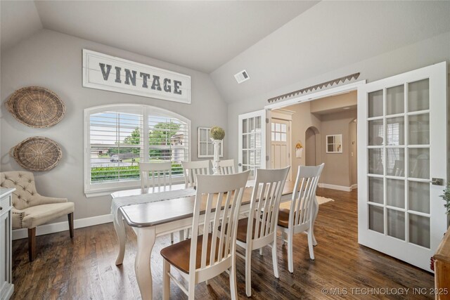 10350 E 122nd St S, Bixby, OK 74008 - dining area featuring lofted ceiling, baseboards, dark wood-style floors, and arched walkways