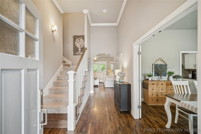 10350 E 122nd St S, Bixby, OK 74008 - entrance foyer featuring a towering ceiling, arched walkways, dark wood-type flooring, stairway, and ornamental molding