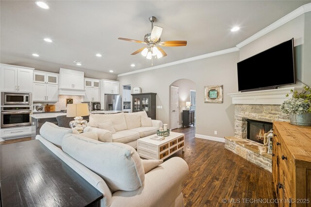 10350 E 122nd St S, Bixby, OK 74008 - living area with arched walkways, a ceiling fan, baseboards, ornamental molding, and recessed lighting