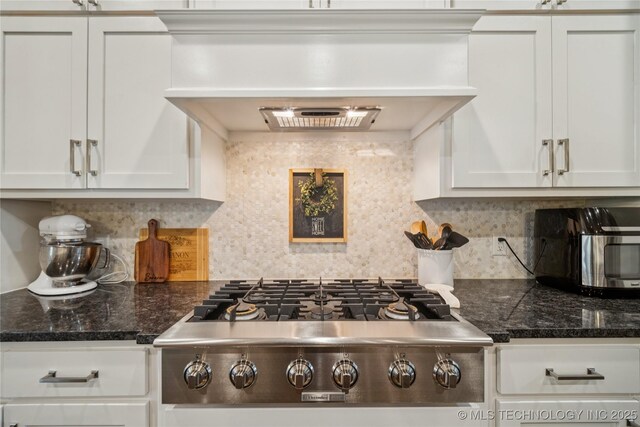 10350 E 122nd St S, Bixby, OK 74008 - kitchen featuring stainless steel appliances, white cabinets, dark countertops, and decorative backsplash