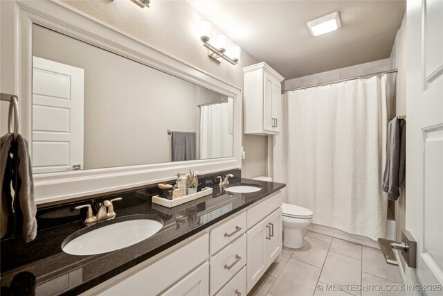 10350 E 122nd St S, Bixby, OK 74008 - full bathroom featuring double vanity, toilet, and tile patterned flooring