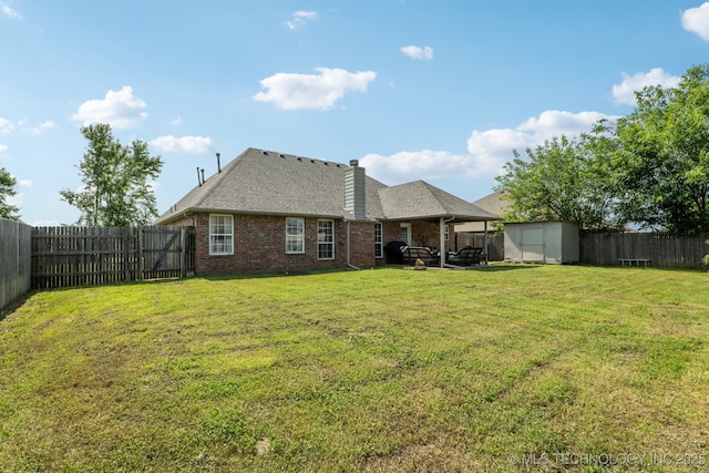 13 Cedar St, Kiefer, OK 74041 - back of property featuring a chimney, brick siding, a patio area, and a shingled roof