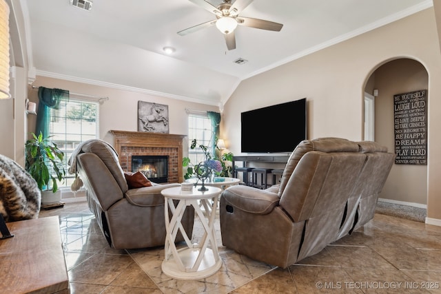 13 Cedar St, Kiefer, OK 74041 - living area with healthy amount of natural light, crown molding, a brick fireplace, a ceiling fan, and arched walkways
