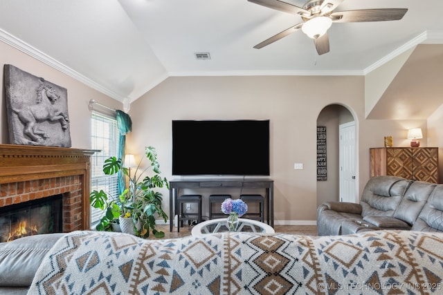 13 Cedar St, Kiefer, OK 74041 - living room with a brick fireplace, ceiling fan, baseboards, crown molding, and arched walkways