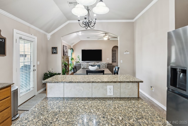 13 Cedar St, Kiefer, OK 74041 - kitchen with arched walkways, stainless steel refrigerator with ice dispenser, a ceiling fan, a chandelier, and vaulted ceiling