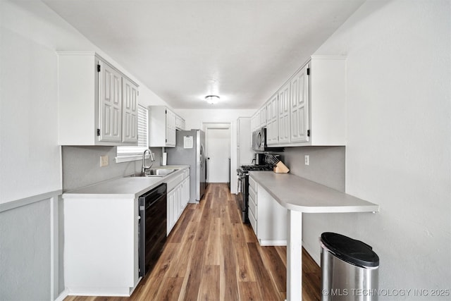 321 W 50th Pl, Sand Springs, OK 74063 - kitchen featuring appliances with stainless steel finishes, a sink, light countertops, and white cabinetry