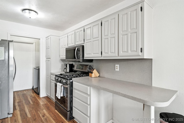 321 W 50th Pl, Sand Springs, OK 74063 - kitchen featuring appliances with stainless steel finishes, white cabinetry, wood finished floors, and light countertops