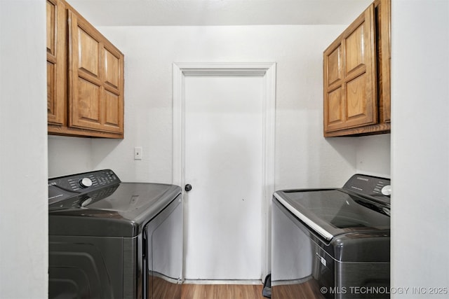 321 W 50th Pl, Sand Springs, OK 74063 - laundry room featuring washer and dryer, cabinet space, and wood finished floors