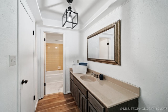 321 W 50th Pl, Sand Springs, OK 74063 - full bathroom featuring vanity, wood finished floors, washtub / shower combination, and a textured wall