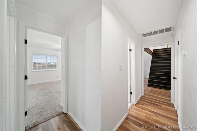 321 W 50th Pl, Sand Springs, OK 74063 - hallway featuring wood finished floors, stairway, and baseboards