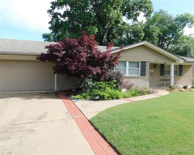 6619 E 57th St, Tulsa, OK 74145 - view of front of house with brick siding, a front yard, a garage, and concrete driveway