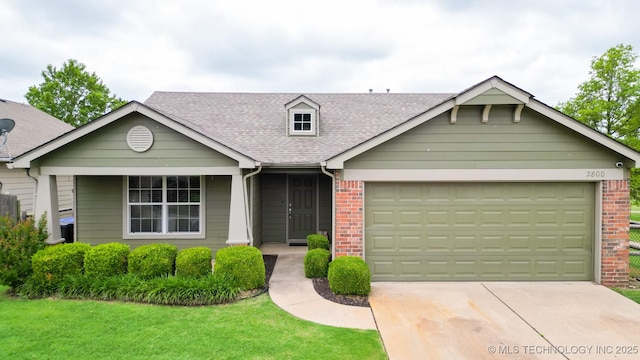 2800 N 20th St, Broken Arrow, OK 74012 - view of front facade featuring roof with shingles, a garage, concrete driveway, and brick siding