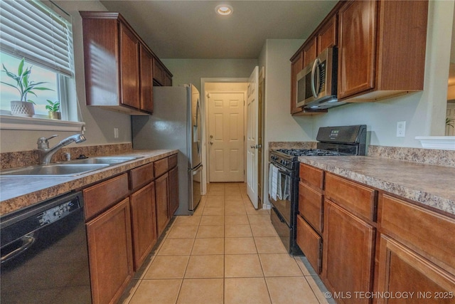 2800 N 20th St, Broken Arrow, OK 74012 - kitchen with black appliances, a sink, light tile patterned floors, brown cabinets, and recessed lighting