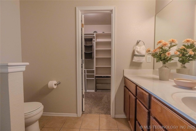 2800 N 20th St, Broken Arrow, OK 74012 - bathroom with toilet, vanity, a spacious closet, tile patterned flooring, and baseboards