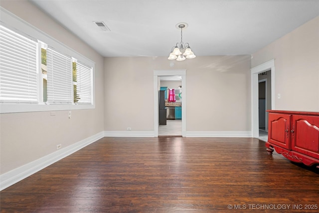 700 D St NW, Ardmore, OK 73401 - empty room with a chandelier and wood finished floors