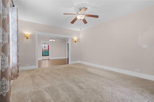 700 D St NW, Ardmore, OK 73401 - carpeted empty room with a ceiling fan and a chandelier