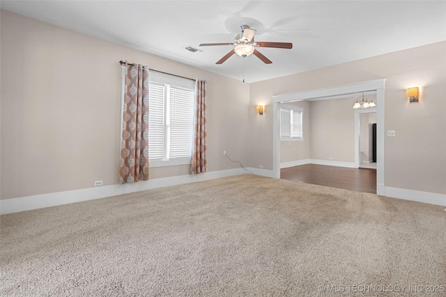 700 D St NW, Ardmore, OK 73401 - unfurnished room featuring carpet, ceiling fan, and a chandelier