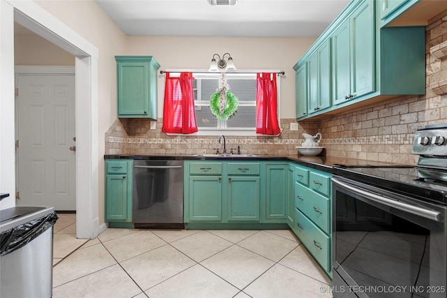 700 D St NW, Ardmore, OK 73401 - kitchen featuring appliances with stainless steel finishes, dark countertops, tasteful backsplash, and light tile patterned floors