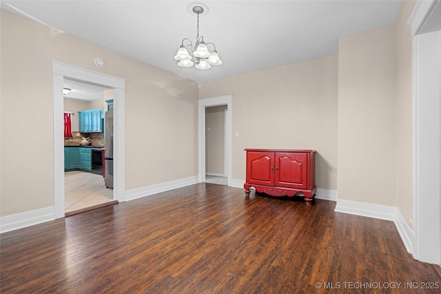700 D St NW, Ardmore, OK 73401 - unfurnished room featuring a chandelier and wood finished floors
