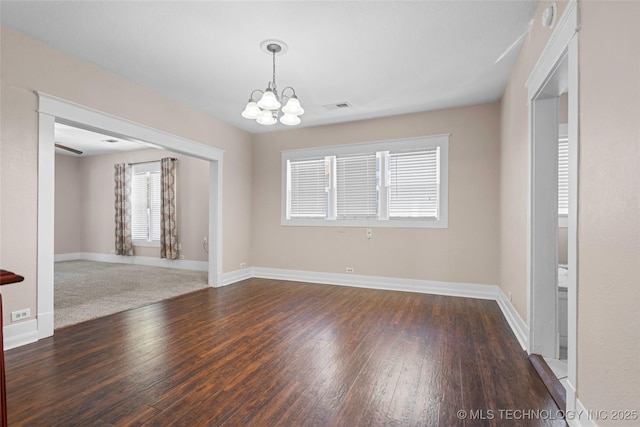 700 D St NW, Ardmore, OK 73401 - spare room featuring a chandelier and wood finished floors