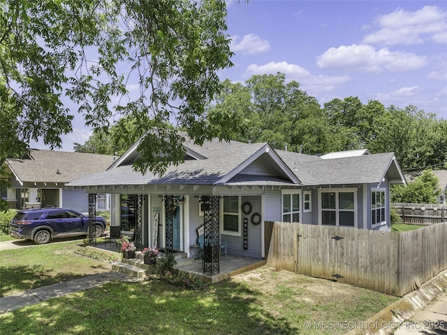 700 D St NW, Ardmore, OK 73401 - view of front of home featuring a shingled roof and covered porch