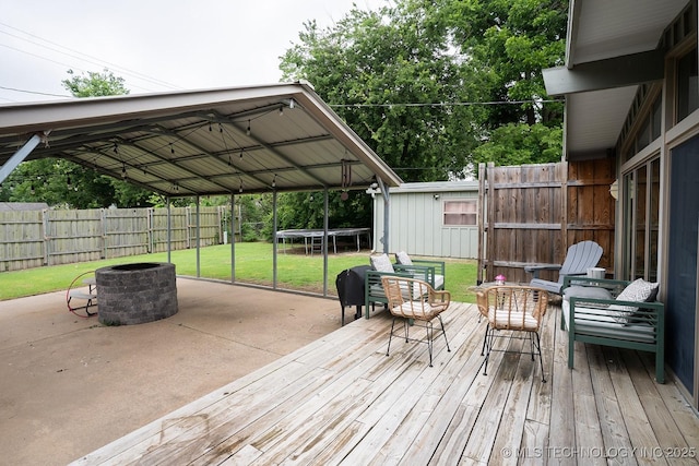 5770 E 26th St, Tulsa, OK 74114 - deck featuring a trampoline and an outdoor fire pit