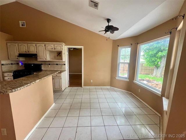915 Aspenwood St, Cleveland, OK 74020 - kitchen featuring vaulted ceiling, ceiling fan, light tile patterned floors, under cabinet range hood, and decorative backsplash