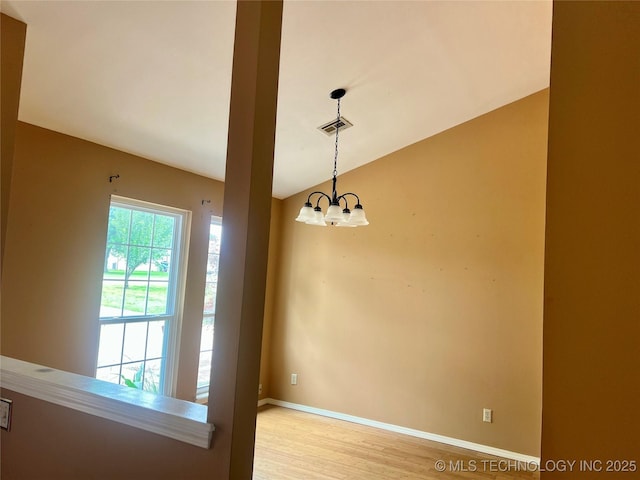 915 Aspenwood St, Cleveland, OK 74020 - empty room featuring light wood-style floors, a chandelier, vaulted ceiling, and baseboards