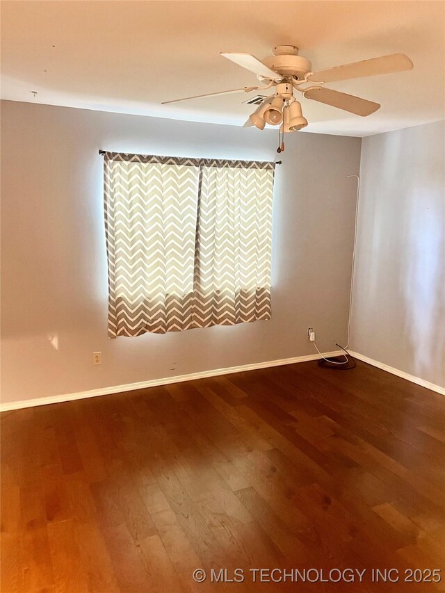 915 Aspenwood St, Cleveland, OK 74020 - empty room featuring dark wood-style flooring, ceiling fan, and baseboards