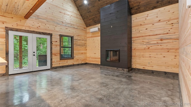 4396 E Cheadle Rd, Milburn, OK 73450 - unfurnished living room featuring french doors, finished concrete floors, high vaulted ceiling, wood walls, and a multi sided fireplace