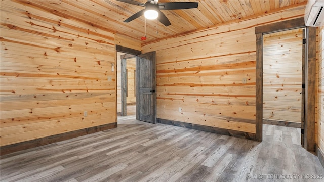 4396 E Cheadle Rd, Milburn, OK 73450 - empty room featuring a ceiling fan, a wall mounted AC, wood walls, wooden ceiling, and wood finished floors