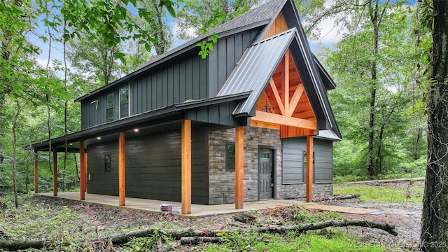 4396 E Cheadle Rd, Milburn, OK 73450 - view of side of property featuring stone siding and board and batten siding
