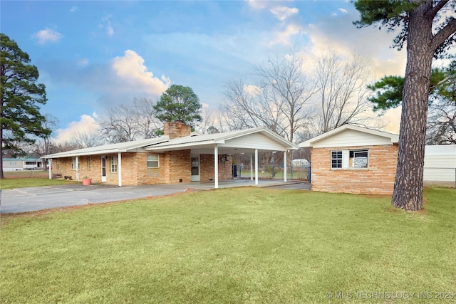 200 S K St, Quinton, OK 74561 - view of front facade featuring a chimney, brick siding, a carport, and a gate