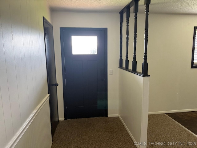 1950 Cimmaron, Wilson, OK 73463 - doorway to outside featuring carpet floors and a textured ceiling