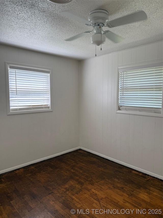1950 Cimmaron, Wilson, OK 73463 - unfurnished room with dark wood finished floors, a ceiling fan, and a textured ceiling