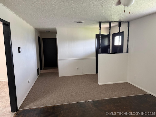 1950 Cimmaron, Wilson, OK 73463 - carpeted spare room featuring a textured ceiling and baseboards